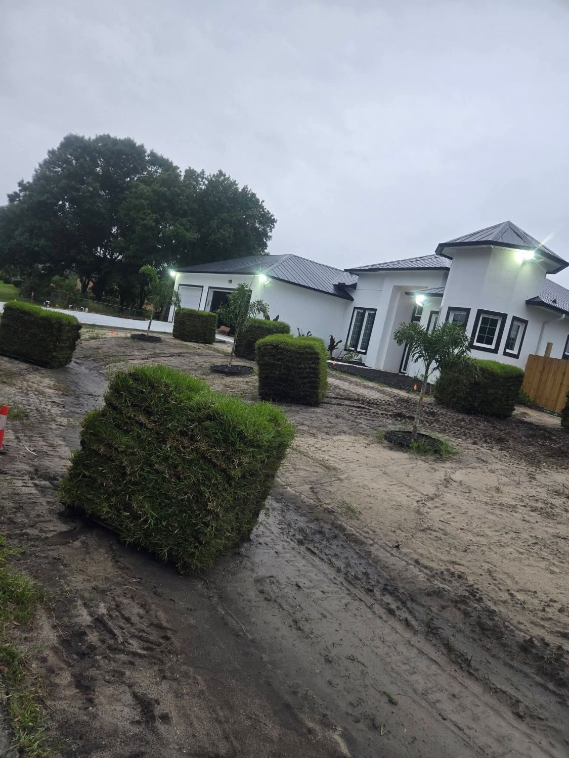 Pallets of sod staged on a new home job site